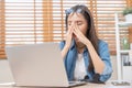 Exhausted, stressed asian young business woman working, took off glasses, massage nose from dry eyes, suffer on hard work while Royalty Free Stock Photo