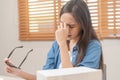 Exhausted, stressed asian young business woman working, took off glasses, massage nose from dry eyes, suffer on hard work while Royalty Free Stock Photo