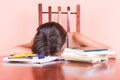 Exhausted student sleeping with her head on a table