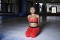 Exhausted sweaty Asian woman in sport clothes breathing and stretching after hard training fitness workout