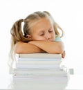 Exhausted sweet cute blonde girl sleeping on a pile of schoolbooks after being studying hard isolated on a withe background in too