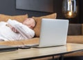 Exhausted tired businessman lying on sofa in office, relaxing after hard work day. Overtime work, overload and burnout Royalty Free Stock Photo