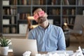 Exhausted tired businessman with stickers on eyes sleeping at workplace