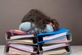 Exhausted tired woman sleeping on a pile of file folders, burnout, stress and overworked, pressure at work Royalty Free Stock Photo