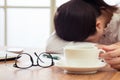 Exhausted and tired young businesswoman sleeping on desk Royalty Free Stock Photo