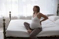Exhausted unhappy late pregnant woman suffering from backache