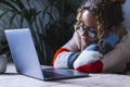 Exhausted woman asleep using computer in office home workplace. Tired business entrepreneur sleeping in front of the laptop. Royalty Free Stock Photo