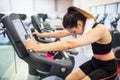 Exhausted woman on the exercise bike Royalty Free Stock Photo