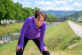 Exhausted woman jogger taking a break