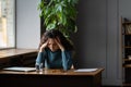 Exhausted woman sit at desk with closed laptop tired of overwork, burnout and lack of inspiration