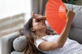 Exhausted woman use hand fan suffer from heat Royalty Free Stock Photo