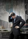 Exhausted worried businessman outdoors in stress and depression Royalty Free Stock Photo