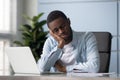 Exhausted young african american employee sleeping at workplace. Royalty Free Stock Photo