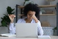 Tired African American woman worker suffer from headache