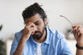 Exhausted Young Arab Man Taking Off Glasses, Feeling Eyes Fatigue Royalty Free Stock Photo