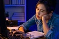 Exhausted young Asian creative feeling sleepy, looking on pc. Stratagem. Royalty Free Stock Photo