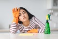 Exhausted young asian lady with dust cloth, copy space Royalty Free Stock Photo
