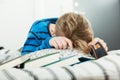 Exhausted young boy asleep on his text books Royalty Free Stock Photo