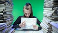 Exhausted young business woman office employee at the desk working late at night overloaded with paperwork. Female on Royalty Free Stock Photo