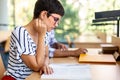 Exhausted young female studying and preparing for exam in college library. Education people concept Royalty Free Stock Photo