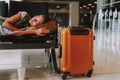 Exhausted young girl is sleeping at airport Royalty Free Stock Photo