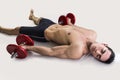 Exhausted young male bodybuilder resting on floor