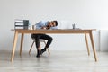 Exhausted Young Man Sleeping At Work Sitting At Desk Royalty Free Stock Photo