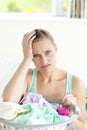 Exhausted young woman doing the laundry