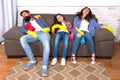 Exhausting cleaning day. Family mom dad and daughter with cleaning supplies sit on couch. Family care about cleanliness Royalty Free Stock Photo