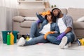 Exhausting Spring-Cleaning. Tired african couple resting on floor after tidying flat