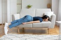 Exhausted Girl Lying On Couch Resting At Home