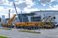 Exhibition area with cranes and excavators from XCMG at Bauma CCT Russia 2021. Preparations for the opening of a