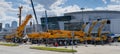 Exhibition area with cranes and excavators from XCMG at Bauma CCT Russia 2021. Preparations for the opening of a