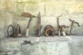 The exhibition of blacksmith craft work examples on the wall in Local Ethnological Museum . Old rusty blacksmith tools