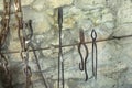 The exhibition of blacksmith craft work examples on the wall in Local Ethnological Museum . Old rusty blacksmith tools