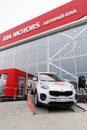 Exhibition car stands in front of the building of KIA MOTORS car selling and service center