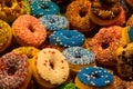 Exhibition of colorful donuts decorated with fancy crumbles in the market hall of Rotterdam, Netherlands Royalty Free Stock Photo