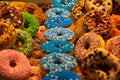 Exhibition of colorful donuts decorated with fancy crumbles in the market hall of Rotterdam, Netherlands Royalty Free Stock Photo