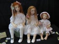 Dolls of three girls. Exhibition of handmade dolls.