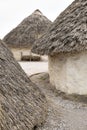 Exhibition neolithic house at Stonehenge, Salisbury, Wiltshire, England with hazel thatched roof and straw hay daubed walls Royalty Free Stock Photo