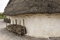 Exhibition neolithic house at Stonehenge, Salisbury, Wiltshire, England with hazel thatched roof and straw hay daubed walls Royalty Free Stock Photo