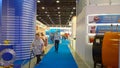 Exhibition in a new convention and conference expo center. Cleaning woman vacuuming the floor in trade show hall. Service staff.