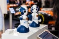 Exhibition stand of NTT Group comapany with two small robots on fair Cebit 2017 in Hannover Messe, Germany