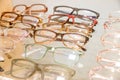 Exhibitor of glasses consisting of shelves of fashionable glasses shown on a wall at the optical shop. optics, health Royalty Free Stock Photo