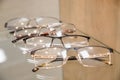 Exhibitor of glasses consisting of shelves of fashionable glasses shown on a wall at the optical shop. optics, health
