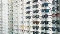 Exhibitor of glasses consisting of shelves of fashionable glasses shown on a wall at the optical shop