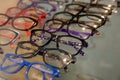 Exhibitor of glasses consisting of shelves of fashionable glasses shown on a wall at the optical shop. Colorful Elegant Royalty Free Stock Photo