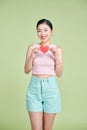 exhilarated woman holding a valentine greeting card in hands