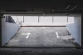 Exit entrance of underground car parking with arrows road sign