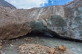 Exit of ice cave into the Vallelunga glacier crossed by a subglacial stream Royalty Free Stock Photo